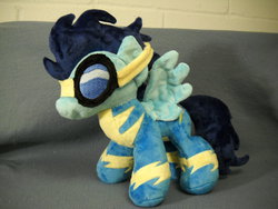 Size: 1024x768 | Tagged: safe, artist:xsjado78, soarin', pegasus, pony, g4, clothes, goggles, irl, photo, pie, plushie, solo, spread wings, that pony sure does love pies, uniform, wings, wonderbolts uniform