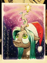 Size: 599x798 | Tagged: safe, artist:andy price, queen chrysalis, g4, :3, christmas, christmas lights, cute, cutealis, fangs, female, hat, looking up, santa hat, smiling, solo, traditional art