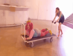 Size: 484x372 | Tagged: source needed, safe, artist:glasmond, artist:schpog, pinkie pie, rainbow dash, human, galacon, g4, animated, ass, butt, cart, convention, converse, cosplay, defictionalization, female, irl, irl human, lesbian, luggage cart, photo, ship:pinkiedash, shipping, shoes, slapping, spanking