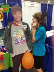 Size: 720x960 | Tagged: safe, human, bronycon, balloon, booth, irl, irl human, photo, zack efron