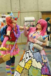 Size: 1366x2048 | Tagged: safe, artist:tsukino-con, madame leflour, pinkie pie, human, g4, 2013, backpack, clothes, convention, cosplay, duality, fight, fingerless gloves, gloves, hat, irl, irl human, party hat, party horn, photo, pinkamena diane pie, rubber duck, tsukino-con