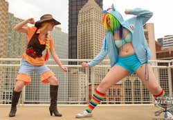 Size: 878x612 | Tagged: safe, applejack, rainbow dash, human, g4, belly button, belly piercing, bellyring, clothes, cosplay, cowbow vest, high heel boots, hoodie, irl, irl human, midriff, photo, piercing, rainbow socks, shorts, socks, striped socks