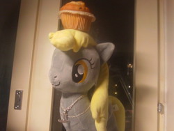 Size: 500x375 | Tagged: safe, artist:onlyfactory, derpy hooves, pegasus, pony, g4, bootleg, female, irl, mare, muffin, necklace, photo, plushie, toy, waifu, window