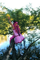 Size: 1066x1600 | Tagged: safe, artist:sewingintherain, pinkie pie, human, g4, clothes, cosplay, hat, irl, irl human, mary janes, photo, skirt, socks, solo, striped socks, top hat, tree, water