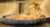 Size: 1200x637 | Tagged: safe, artist:jamescorck, applejack, earth pony, pony, g4, apple pie, applesauce, appletini, female, food, foodplay, looking at you, mare, on back, pie tin, smiling, solo