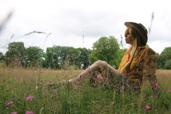 Size: 4272x2848 | Tagged: safe, artist:paranoiaagentothello, applejack, human, g4, cosplay, flower, grass, irl, irl human, outdoors, photo, sitting, solo
