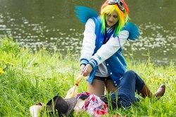 Size: 1280x853 | Tagged: safe, artist:vylka, applejack, rainbow dash, human, g4, clothes, cosplay, goggles, grass, irl, irl human, jacket, jeans, on back, photo, ponies grabbing other ponies, pulling, resting, shorts, varsity jacket, water