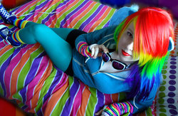 Size: 1024x666 | Tagged: safe, artist:amphyrainbows, rainbow dash, human, g4, bed, cosplay, irl, irl human, looking at you, photo, solo