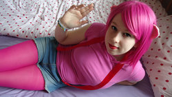 Size: 1024x579 | Tagged: safe, artist:amphyrainbows, pinkie pie, human, g4, bed, cosplay, irl, irl human, looking at you, photo, solo, suspenders, waving