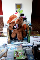 Size: 533x800 | Tagged: safe, artist:erdbeerprinz, button mash, earth pony, pony, g4, blank flank, colt, foal, hat, hooves, irl, male, photo, pile, plushie, propeller hat, solo, throne, video game