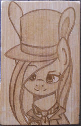 Size: 1394x2165 | Tagged: safe, artist:augustbebel, fluttershy, g4, alice in wonderland, bunny ears, crossover, hat, irl, mad hatter, photo, pyrography, solo, traditional art, woodwork
