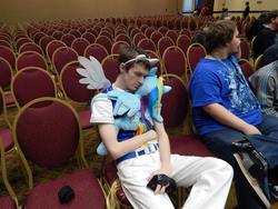 Size: 960x720 | Tagged: source needed, safe, rainbow dash, human, g4, backpack, brony, build-a-bear, chair, convention, cosplay, iphone, irl, irl human, photo, plushie, pony ears, sunglasses