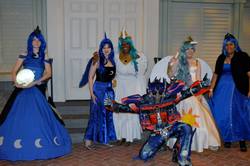 Size: 2048x1362 | Tagged: safe, artist:marchmochahare, artist:mintyblitzz, princess celestia, princess luna, human, g4, 2014, action pose, clothes, convention, cosplay, crossover, dress, female, irl, irl human, katsucon, katsucon 2014, moon, multeity, optimus prime, photo, tangible heavenly object, transformers