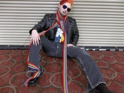 Size: 1034x772 | Tagged: safe, artist:ichankobayashi, rainbow dash, human, g4, 2013, a-kon, clothes, convention, cosplay, irl, irl human, jacket, photo, rainbow blitz, rule 63, scarf, sitting, solo, sunglasses