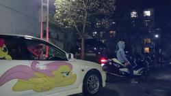 Size: 599x337 | Tagged: safe, fluttershy, rainbow dash, g4, 2014, brony, car, clothes, convention, customized toy, decal, hoodie, irl, itasha, japan, japan ponycon, motorcycle, night, photo