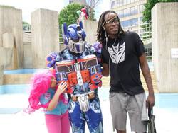 Size: 960x720 | Tagged: safe, pinkie pie, human, g4, cosplay, decepticon, irl, irl human, nom, optimus prime, photo, transformers