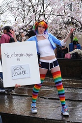 Size: 2526x3789 | Tagged: safe, artist:donknnj, rainbow dash, human, g4, 20% cooler, 2012, clothes, cosplay, goggles, high res, irl, irl human, midriff, northern california cherry blossom festival, photo, rainbow socks, shorts, sign, socks, striped socks