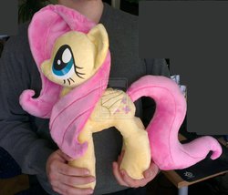 Size: 966x827 | Tagged: dead source, safe, artist:epicrainbowcrafts, fluttershy, human, pegasus, pony, g4, deviantart watermark, female, irl, irl human, mare, obtrusive watermark, photo, plushie, watermark