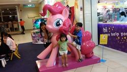 Size: 4128x2322 | Tagged: safe, pinkie pie, twilight sparkle, human, equestria girls, g4, irl, irl human, life-size pinkie statue, malaysia, my little pony logo, photo, statue, target demographic, toys r us, warning sign