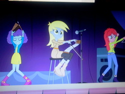 Size: 640x480 | Tagged: safe, screencap, blueberry pie, derpy hooves, raspberry fluff, equestria girls, g4, my little pony equestria girls: rainbow rocks, background human, cowbell, female, musical instrument, musical saw, saw, triangle, trio, trio female