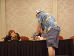 Size: 4608x3456 | Tagged: safe, human, trotcon, trotcon 2015, g.m. berrow, irl, irl human, m.a. larson, pennyroyal academy, photo, signing, steffan andrews