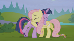 Size: 1919x1076 | Tagged: safe, screencap, fluttershy, twilight sparkle, alicorn, pony, g4, the hooffields and mccolts, booty call, butt, discovery family logo, duo, female, flutterbutt, folded wings, glowing cutie mark, hug, mare, plot, smiling, twilight sparkle (alicorn), wings