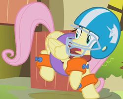 Size: 523x423 | Tagged: safe, screencap, fluttershy, pegasus, pony, dragonshy, g4, american football, cropped, female, floaty, folded wings, football helmet, helmet, inner tube, mare, outfit catalog, solo, startled, wings