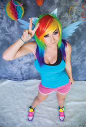 Size: 613x900 | Tagged: safe, artist:jessica nigri, rainbow dash, human, g4, cleavage, clothes, cosplay, costume, female, irl, irl human, peace sign, photo, shorts, sleeveless, tank top