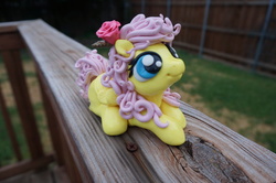 Size: 1024x680 | Tagged: safe, artist:sculpedetails, fluttershy, g4, figure, flower, flower in hair, folded wings, irl, looking up, lying, photo, rose, sculpture, solo