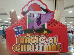 Size: 1920x1440 | Tagged: safe, artist:starlessnight22, twilight sparkle, alicorn, pony, g4, official, candy, candy cane, christmas, cute, female, food, hasbro, hasbro logo, hat, irl, magic of christmas, mare, nose wrinkle, photo, raised hoof, retail, santa hat, scrunchy face, sitting, spread wings, standee, store display, twilight sparkle (alicorn), wide eyes