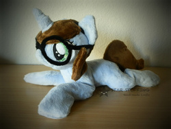 Size: 1024x768 | Tagged: safe, artist:starmassacre, oc, oc only, oc:quiz, pony, unicorn, beanie (plushie), female, fluffy, glasses, horn, irl, mare, photo, plushie, prone, smiling, solo