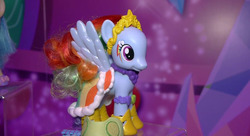 Size: 844x458 | Tagged: safe, rainbow dash, pony, g4, alternative cutie mark placement, beauty mask, clothes, cucumber, doll, dress, facial cutie mark, fashion style, female, gala dress, irl, photo, rainbow dash always dresses in style, solo, toy, toy fair 2015