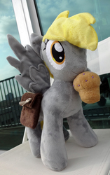 Size: 2936x4680 | Tagged: safe, artist:janellesplushies, derpy hooves, pegasus, pony, g4, female, irl, mare, mouth hold, muffin, outdoors, photo, plushie, solo