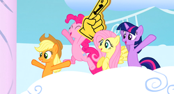 Size: 1099x597 | Tagged: safe, screencap, applejack, fluttershy, pinkie pie, twilight sparkle, earth pony, pegasus, pony, unicorn, g4, sonic rainboom (episode), cheering, cloudiseum, female, foam finger, mare, smiling, unicorn twilight