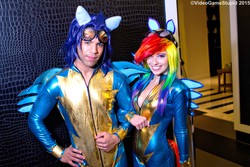 Size: 5183x3456 | Tagged: dead source, safe, artist:cosplayhazard, artist:supersandcosplay, rainbow dash, soarin', human, g4, clothes, cosplay, duo, fake ears, fake wings, female, goggles, irl, irl human, linked arms, male, photo, uniform, wonderbolts, wonderbolts uniform