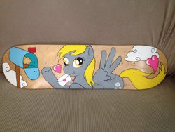 Size: 1024x768 | Tagged: safe, artist:matteglaze, derpy hooves, pegasus, pony, g4, customized toy, female, heart, letter, mare, mouth hold, muffin, scrunchy face, skateboard