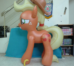 Size: 1005x893 | Tagged: safe, applejack, earth pony, inflatable pony, pony, g4, applejack's hat, banana, banana for scale, bootleg, chinese, cowboy hat, female, hat, hongyi, inflatable, inflatable earth pony, irl, mare, opaque inflatable, photo, side view, solo, standing