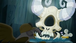 Size: 1641x931 | Tagged: safe, screencap, arimaspi, gilda, cyclops, griffon, g4, the lost treasure of griffonstone, abysmal abyss, ambiguous gender, arimaspi skull, bone, dead, discovery family logo, hard hat, hat, skull, solo, you know for kids