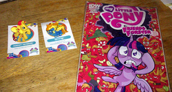 Size: 800x431 | Tagged: safe, idw, photographer:drpain, big macintosh, spitfire, sunset shimmer, twilight sparkle, alicorn, pony, g4, blind bag, comic, female, irl, mare, photo, toy, twilight sparkle (alicorn)