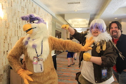 Size: 1280x853 | Tagged: safe, artist:neouka, artist:spainfischer, gilda, griffon, human, g4, clothes, cosplay, cosplay vs furry, fursuit, irl, irl human, larson you magnificent bastard, m.a. larson, photo, photobomb, sydneyroo(coser)