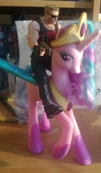 Size: 832x1412 | Tagged: safe, princess celestia, g4, blue wings, colored wings, desk, doll, duke nukem, gun, irl, photo, pinklestia, riding, toy, toy pony cavalry, wings