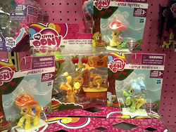 Size: 650x488 | Tagged: safe, photographer:drpain, apple fritter, apple munchies, applejack, jonagold, marmalade jalapeno popette, earth pony, pony, g4, apple family member, applejack's hat, background pony, blind bag, bucking, cider stand, cowboy hat, female, hat, irl, mare, photo, raised hoof, rearing, saddle, tack, toy