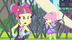 Size: 1136x640 | Tagged: safe, screencap, fluttershy, sour sweet, equestria girls, g4, my little pony equestria girls: friendship games, archery, arrow, bow (weapon), bow and arrow, female, puffy cheeks, solo