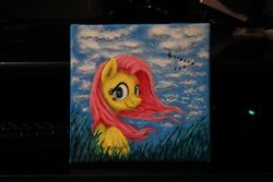 Size: 1280x854 | Tagged: safe, artist:horseez, fluttershy, g4, acrylic painting, female, looking at you, painting, photo, sky, solo, traditional art, windswept mane