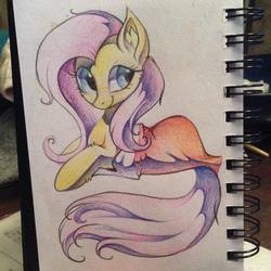 Size: 1080x1080 | Tagged: safe, artist:hioshiru, fluttershy, g4, blanket, colored pencil drawing, female, looking at you, photo, prone, solo, traditional art