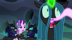 Size: 1280x720 | Tagged: safe, screencap, queen chrysalis, starlight glimmer, changeling, changeling queen, pony, unicorn, g4, to where and back again, armor, changeling armor, changeling feeding, changeling guard, creepy, female, glowing horn, helmet, horn, magic, mare