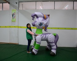 Size: 1185x938 | Tagged: safe, zecora, crystal pony, human, pony, zebra, g4, bootleg, chest touch, crystallized, duo, duo female, female, hongyi, indoors, inflatable, inflatable zebra, inflation valve, irl, irl human, laurel wreath, mare, opaque inflatable, photo, standing, tail, tail wrap, woman