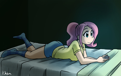 Size: 1069x671 | Tagged: safe, artist:kprovido, fluttershy, human, g4, bed, clothes, female, humanized, prone, shirt, socks, solo, striped socks, t-shirt, video game