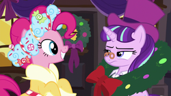 Size: 1280x720 | Tagged: safe, screencap, pinkie pie, snowfall frost, spirit of hearth's warming presents, starlight glimmer, pony, a hearth's warming tail, g4, season 6, clothes, hat, pinkie's present, spectacles, starlight glimmer is not amused, top hat, unamused, wreath