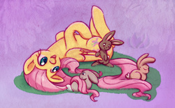 Size: 930x578 | Tagged: safe, artist:raininess, fluttershy, pegasus, pony, rabbit, g4, cute, daaaaaaaaaaaw, female, floppy ears, happy, hnnng, horses doing horse things, legs in air, long mane, long tail, mare, on back, open mouth, shyabetes, smiling, solo, upside down